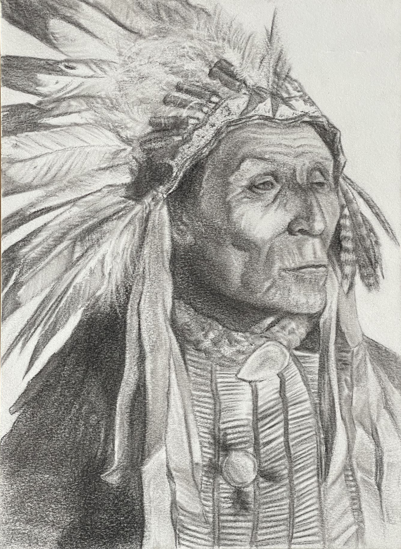 Older Native American Chief wearing full eagle feather headdress and beaded front-piece.