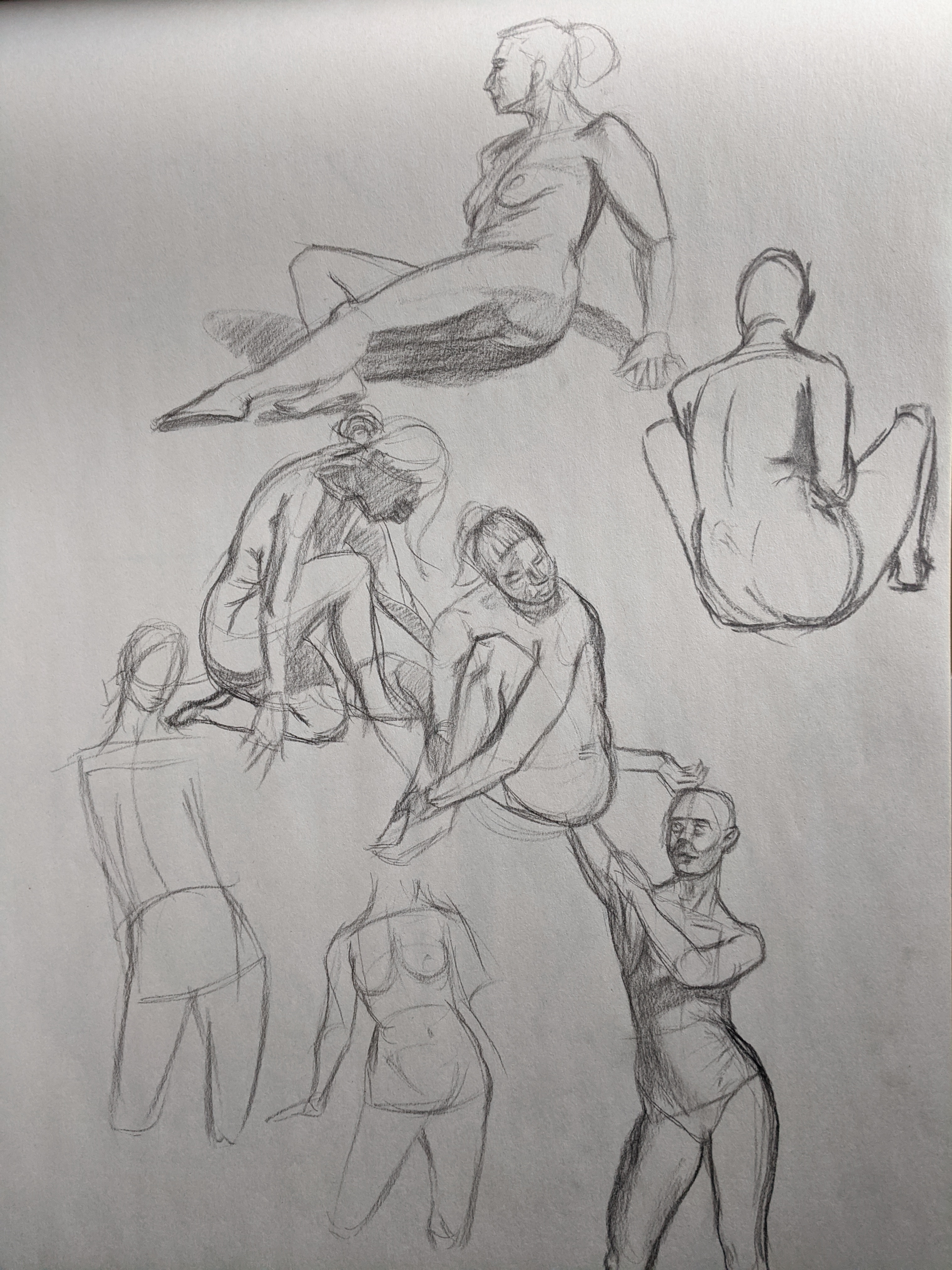 Graphite page of seated and reclining figure gesture studies