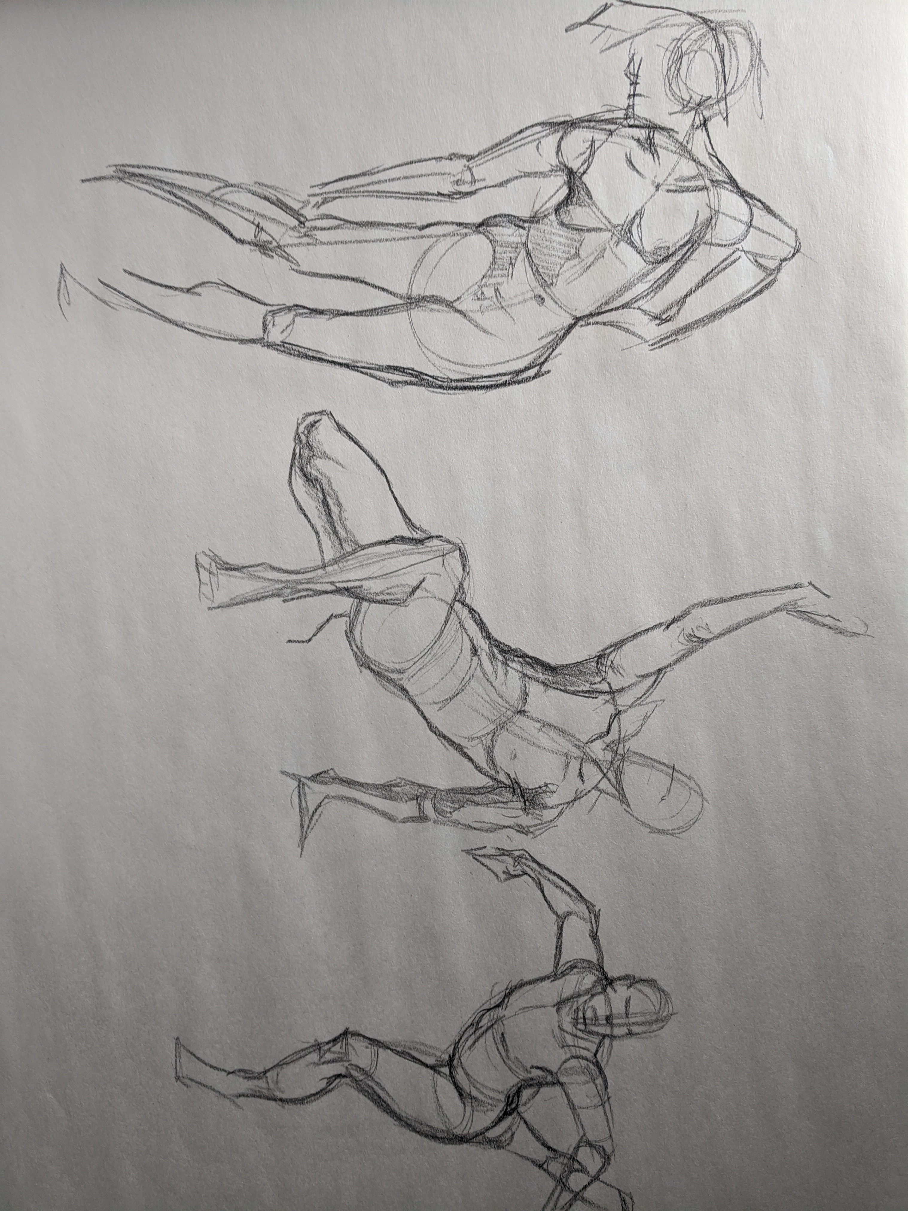 Graphite page of standing, seated, and kneeling figure studies